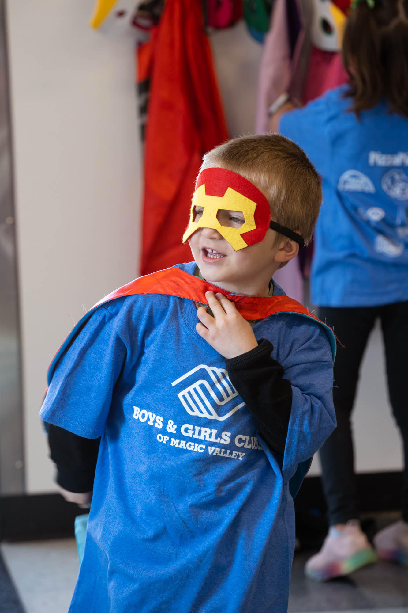 Boy wearing Boys & Girls Club of Magic Valley shirt and super hero costume.